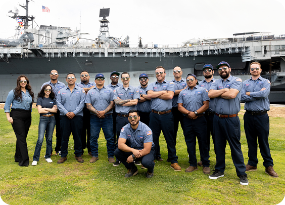 Plumbing Plus team members in front of a company service van.